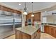 The gourmet kitchen offers an island with granite countertops, stainless steel appliances, and custom cabinetry at 6487 Ashley Dr, Lakeland, FL 33813