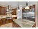 Gourmet kitchen with stainless steel appliances, granite countertops, island, and custom cabinetry at 6487 Ashley Dr, Lakeland, FL 33813