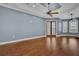 Spacious living room featuring hardwood floors, a modern ceiling fan, and shuttered double doors at 6487 Ashley Dr, Lakeland, FL 33813