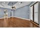 Spacious living room featuring hardwood floors, tray ceilings, and an arched doorway at 6487 Ashley Dr, Lakeland, FL 33813