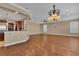 Bright, open-concept living room featuring hardwood floors, recessed lighting and a decorative chandelier at 6487 Ashley Dr, Lakeland, FL 33813