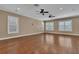 Living room featuring plantation shutters, ceiling fans, and hardwood floors at 6487 Ashley Dr, Lakeland, FL 33813