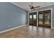 Spacious living room with stone tile floors, a ceiling fan, and French doors leading to the outdoor space at 6487 Ashley Dr, Lakeland, FL 33813