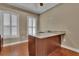 Office area features hardwood floors, plantation shutters, and a built-in desk with granite countertop at 6487 Ashley Dr, Lakeland, FL 33813