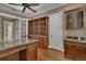 Custom office with beautiful built-in desk, shelving, and cabinet space with granite counter and sink at 6487 Ashley Dr, Lakeland, FL 33813