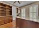 Home office with granite counters, wood cabinets, built-in bookshelves and beautiful wood flooring at 6487 Ashley Dr, Lakeland, FL 33813