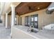 Outdoor kitchen features a wood ceiling, sink, stainless steel grill, and tile countertop at 6487 Ashley Dr, Lakeland, FL 33813