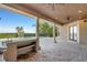 This covered patio features an outdoor kitchen, tile flooring and views of the backyard at 6487 Ashley Dr, Lakeland, FL 33813