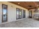 This covered patio features an outdoor kitchen, multiple doors and tile flooring at 6487 Ashley Dr, Lakeland, FL 33813