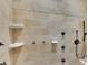 Detailed travertine shower showcasing beautiful design elements and modern fixtures at 6487 Ashley Dr, Lakeland, FL 33813
