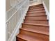 Stairway featuring wooden steps and a white banister at 6487 Ashley Dr, Lakeland, FL 33813