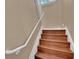 Stairway featuring wooden steps and a white handrail at 6487 Ashley Dr, Lakeland, FL 33813