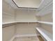 Large walk-in closet featuring custom shelving and hanging rods for clothes and accessories at 6487 Ashley Dr, Lakeland, FL 33813