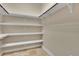 Spacious walk-in closet with custom shelving and hanging rods for ample storage at 6487 Ashley Dr, Lakeland, FL 33813