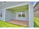 Covered back patio featuring a large window and door leading to the backyard at 1484 Leamington Ln, Winter Haven, FL 33884