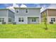 View of the home's backyard and covered patio, featuring a green lawn at 1484 Leamington Ln, Winter Haven, FL 33884
