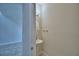 Half bathroom with pedestal sink, brushed nickel faucet, oval mirror and a tile floor at 1484 Leamington Ln, Winter Haven, FL 33884