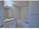 Bathroom featuring a tub, granite vanity, and neutral paint at 1484 Leamington Ln, Winter Haven, FL 33884
