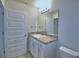 Bathroom boasts white vanity, granite countertop, chrome fixtures, and a coordinating framed mirror at 1484 Leamington Ln, Winter Haven, FL 33884