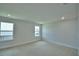 Spacious carpeted bedroom with two windows to allow for natural light at 1484 Leamington Ln, Winter Haven, FL 33884