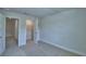 Spacious bedroom features neutral carpet, recessed lighting, and doors leading to a hallway and the closet at 1484 Leamington Ln, Winter Haven, FL 33884