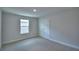 Cozy carpeted bedroom featuring a double door closet and a bright window at 1484 Leamington Ln, Winter Haven, FL 33884