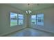 Well-lit dining room with dual windows offering scenic outdoor views and neutral finishes at 1484 Leamington Ln, Winter Haven, FL 33884
