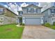 Charming two-story home with a two-car garage, green lawn, and neatly landscaped front yard at 1484 Leamington Ln, Winter Haven, FL 33884