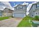 Two-story home with a two-car garage and a concrete driveway, surrounded by green lawns at 1484 Leamington Ln, Winter Haven, FL 33884