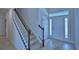 Inviting foyer with ceramic tile floors, staircase with carpet, and natural light from the front door's sidelights at 1484 Leamington Ln, Winter Haven, FL 33884