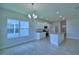 Open-concept kitchen featuring tile flooring, white cabinetry, and a center island with sink at 1484 Leamington Ln, Winter Haven, FL 33884