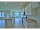 Open-concept kitchen with granite countertops, stainless steel appliances, and an island sink at 1484 Leamington Ln, Winter Haven, FL 33884