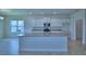 Bright kitchen featuring a granite island, stainless steel appliances, and white cabinetry at 1484 Leamington Ln, Winter Haven, FL 33884