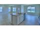 Open concept kitchen with a central island featuring granite countertops and modern appliances at 1484 Leamington Ln, Winter Haven, FL 33884