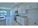 Modern kitchen features white cabinets, stainless steel appliances, and granite countertops at 1484 Leamington Ln, Winter Haven, FL 33884