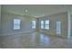 Bright and airy living area with multiple windows and a glass door showcasing tile flooring at 1484 Leamington Ln, Winter Haven, FL 33884
