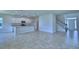 Open floor plan showcases a modern kitchen and sunlit living area with stylish tile floors at 1484 Leamington Ln, Winter Haven, FL 33884