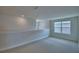 Bright loft area features neutral carpet, natural light from the window and a modern hanging light fixture at 1484 Leamington Ln, Winter Haven, FL 33884