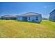 Large green backyard and covered patio, perfect for outdoor living at 4670 Grandview Glen Dr, Auburndale, FL 33823