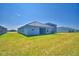 Expansive backyard featuring lush green grass and a modern home exterior at 4670 Grandview Glen Dr, Auburndale, FL 33823
