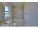 Bright bathroom featuring granite countertop, bathtub with tiled backsplash, and modern fixtures at 4670 Grandview Glen Dr, Auburndale, FL 33823