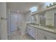 Bathroom featuring granite countertop, a soaking tub, and a walk-in shower with a glass door at 4670 Grandview Glen Dr, Auburndale, FL 33823