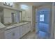 Bathroom featuring dual granite vanity, and a door to an adjoined bedroom at 4670 Grandview Glen Dr, Auburndale, FL 33823