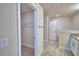 Bathroom featuring a walk-in closet, granite countertop, and wood look tile floors at 4670 Grandview Glen Dr, Auburndale, FL 33823