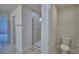 Modern bathroom with tiled walk-in shower and glass door, and a water closet at 4670 Grandview Glen Dr, Auburndale, FL 33823