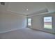 Spacious bedroom with tray ceiling, recessed lighting, and two windows filling the room with natural light at 4670 Grandview Glen Dr, Auburndale, FL 33823