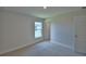 Carpeted bedroom featuring an entrance and window letting in plenty of natural light at 4670 Grandview Glen Dr, Auburndale, FL 33823