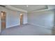 Large bedroom boasting a tray ceiling, recessed lighting, and an ensuite bathroom entrance at 4670 Grandview Glen Dr, Auburndale, FL 33823