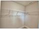 Walk-in closet featuring neutral walls, carpet, and metal shelving for organization at 4670 Grandview Glen Dr, Auburndale, FL 33823