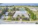 Aerial view of the community clubhouse, pool, tennis courts, and manicured landscaping at 4670 Grandview Glen Dr, Auburndale, FL 33823
